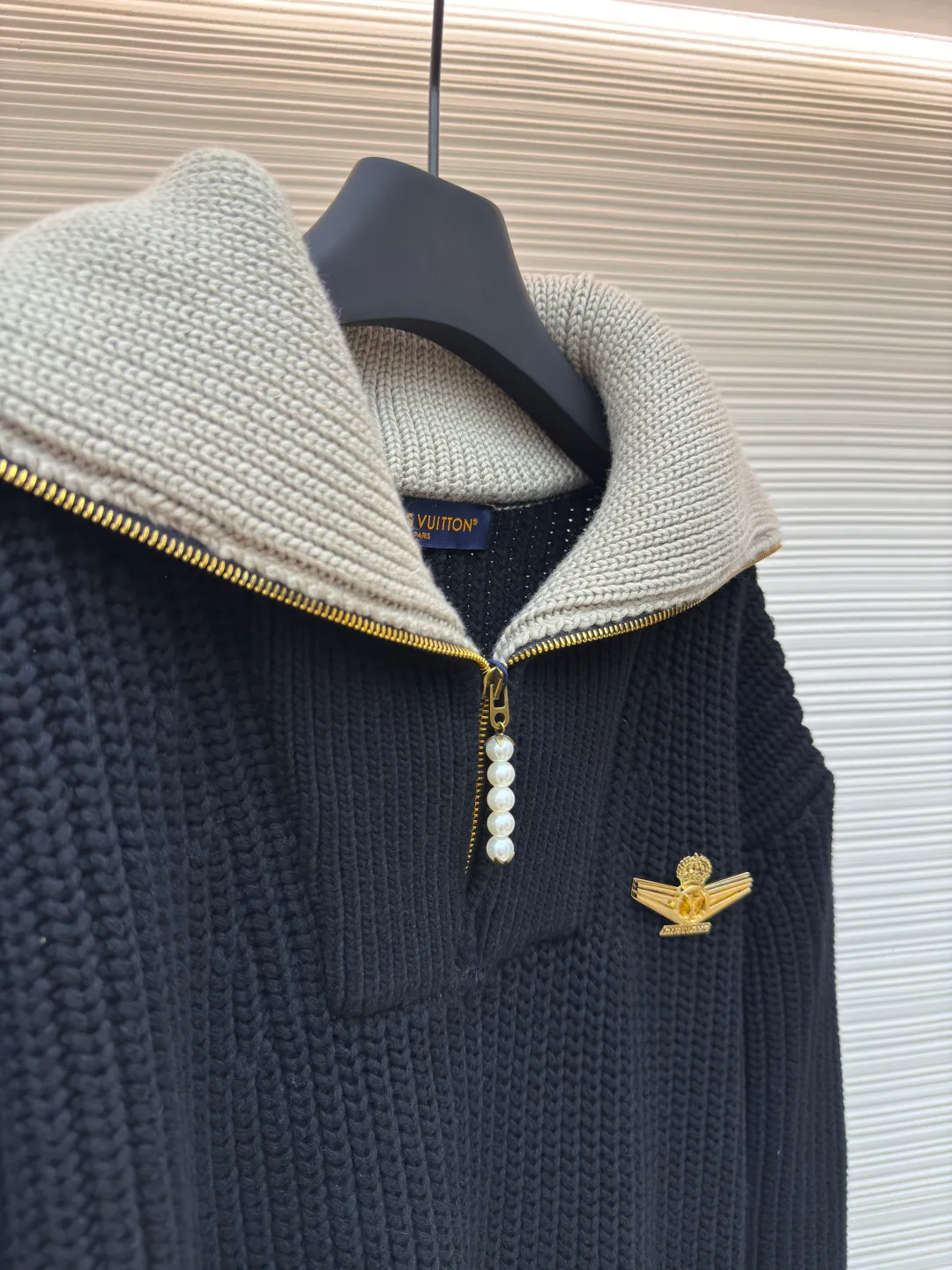 LOUIS VUITTON Pearl Aviator Brooch Lapel Sweater ●Authentic product: 25100 purchased and developed ●Item number: 1680544-D15 ●Fabric: wool blended fabric ●Technology: knitted ●Version: fitted version ●Weight: about 1720g ●Size: XS-S-M-L ●Description: The fabric is made of cotton-wool blended cotton thread, 35% wool, 65% cotton yarn. The ready-to-wear fabric has a soft feel and is thick and slightly elastic. The chest logo is alloy electroplated gold, the zipper is natural mother of pearl, and the pull tabs are electroplated brass. The cuffs have mother-of-pearl and each button has the brand's LOGO. All accessories are developed according to the original version, and every detail and weight of each accessory is restored. This half-zip pullover continues the dandy style of the 2025 spring and summer show. It is made of sheep wool blended with a thick cable knit, and the body and collar are rendered in different colors. The LV Airways brooch sits elegantly on the chest, and the zipper pull and cuffs sparkle with pearlescent light. The overall routing is straight and delicate, the fabric is comfortable and soft, and the color is consistent without color difference. It can be matched with the same style to create a fashionable look and control various occasions. Customized accessories, complete with three standards, same style for men and women! .